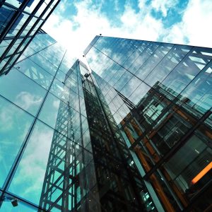  Glass skyscrapers reflecting blue sky and clouds. Ideal for corporate headquarters, finance, compliance, CIPC filing, beneficial ownership, and business growth.